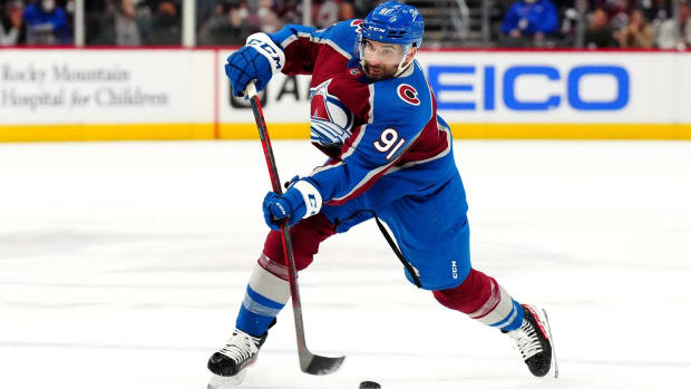 Avalanche forward Nazem Kadri shoots a puck during a game.